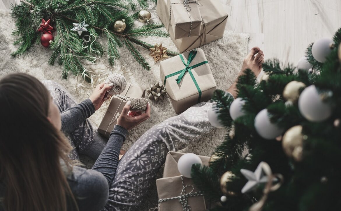 Woman decorating a christmas present
