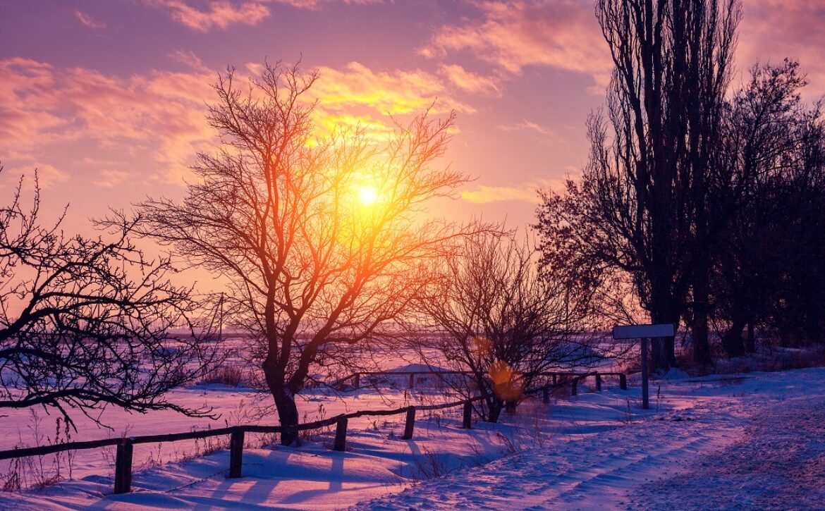 Winter rural landscape at sunset