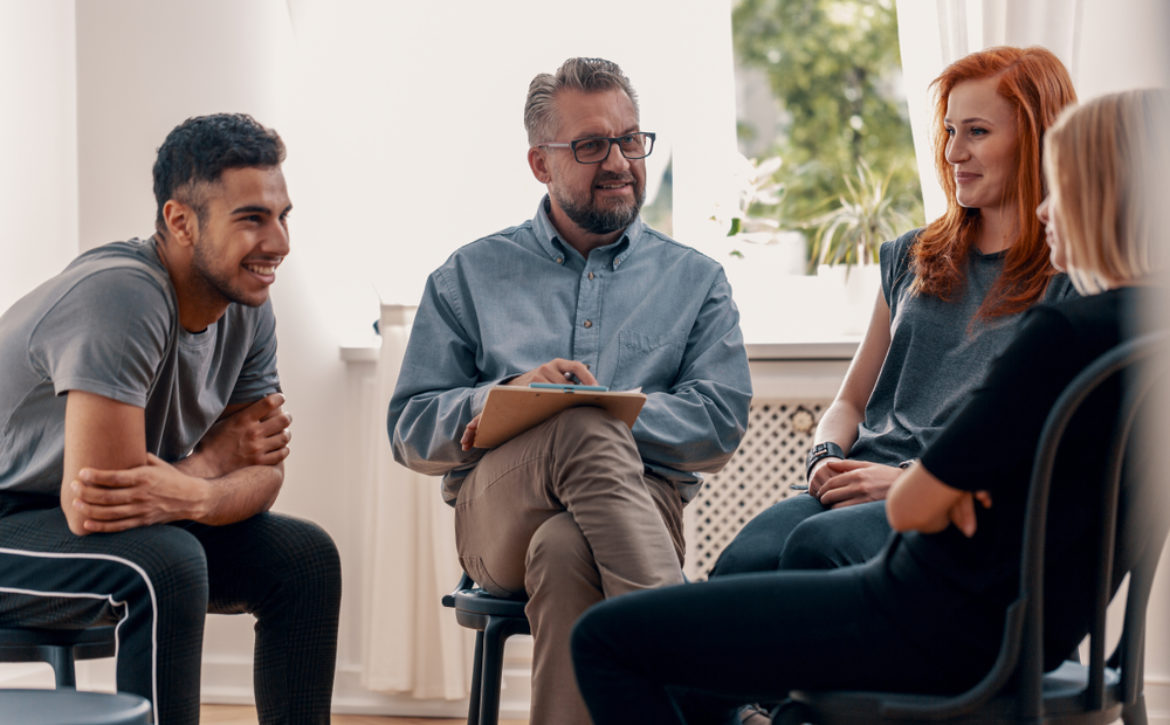 Smiling,Spanish,Man,Talking,To,His,Friends,During,Meeting,For