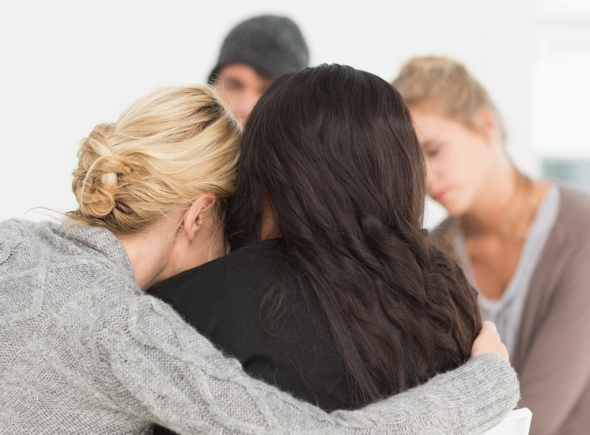 Women,Hugging,In,Rehab,Group,At,Therapy,Session
