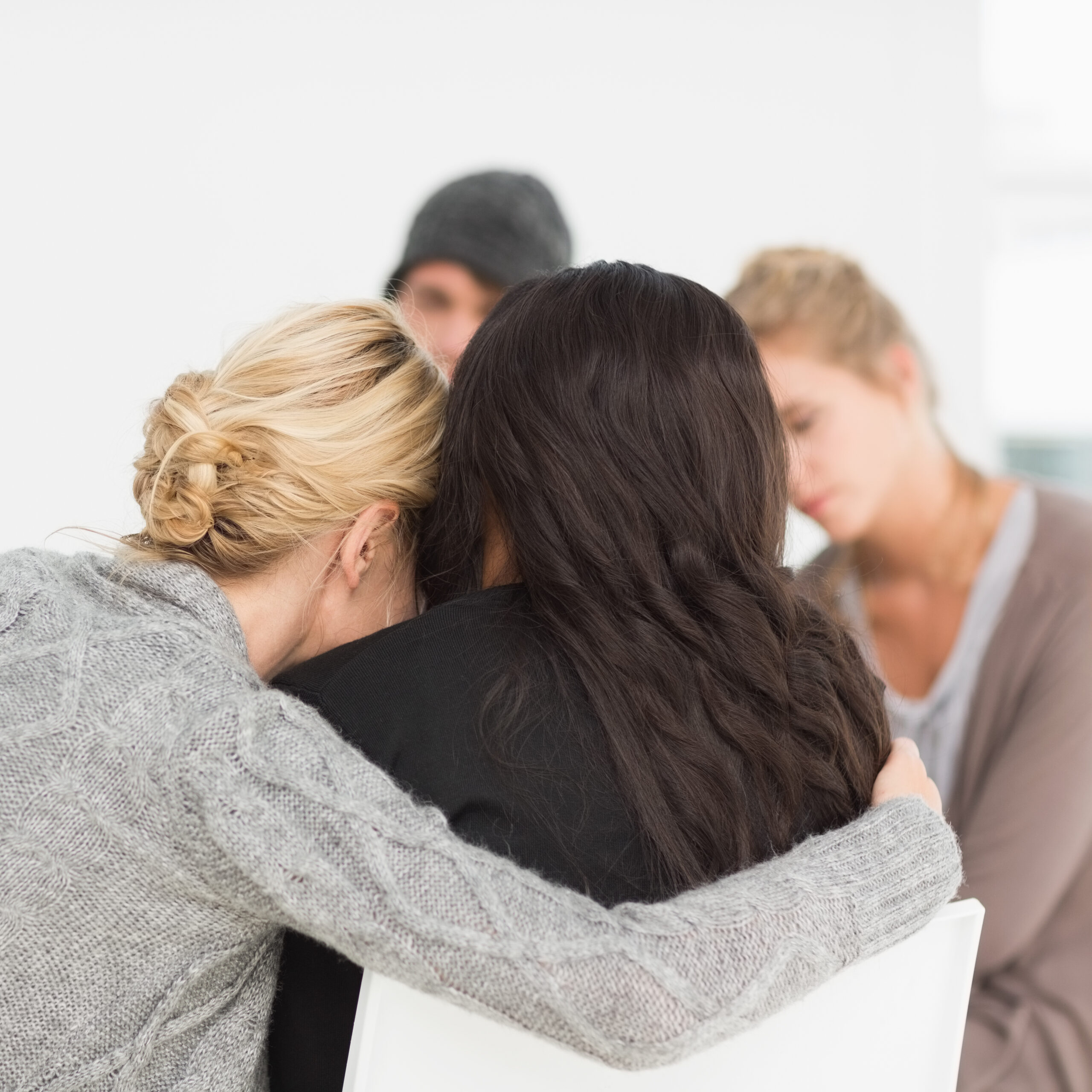 Women,Hugging,In,Rehab,Group,At,Therapy,Session