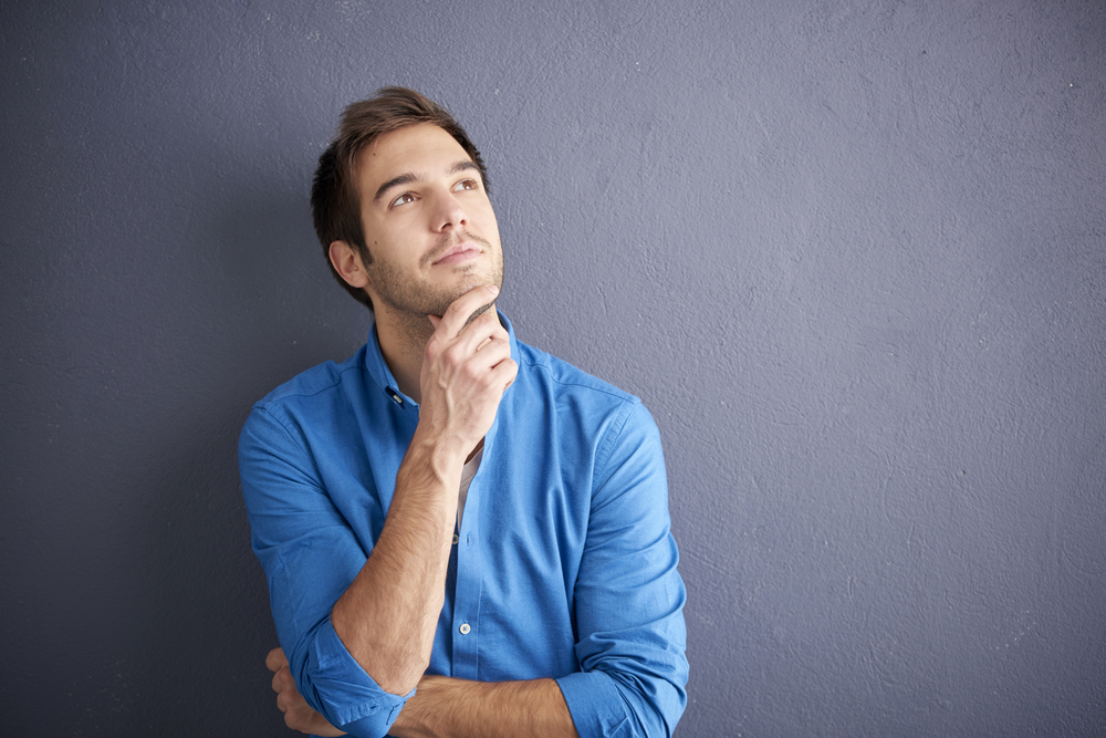 Cropped,Shot,Of,Thoughtful,Young,Man,Standing,By,The,Wall.